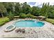 Stunning swimming pool with an attached jacuzzi, stone patio, and gazebo seating at 170 Autry Trl, Johns Creek, GA 30022