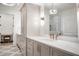 Elegant bathroom featuring quartz countertops, a luxurious mirror, and contemporary lighting at 4585 Ryker Rd, Cumming, GA 30041