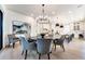 Bright dining room featuring a modern chandelier, painting, and direct access to the kitchen at 4585 Ryker Rd, Cumming, GA 30041
