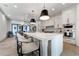Spacious kitchen with island, barstool seating, modern appliances, and white cabinetry at 4585 Ryker Rd, Cumming, GA 30041