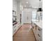 Gourmet kitchen with white cabinets, stainless steel appliances, and a center island with quartz countertop at 4585 Ryker Rd, Cumming, GA 30041