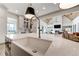 Open concept kitchen with a large island, farmhouse sink, and stainless steel faucet fixture at 4585 Ryker Rd, Cumming, GA 30041