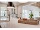 Quartz kitchen island featuring bronze faucet and view to the open living room space at 4585 Ryker Rd, Cumming, GA 30041