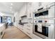 Gourmet kitchen featuring stainless steel appliances, white cabinets, and a Wolf range at 4585 Ryker Rd, Cumming, GA 30041
