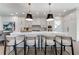 Bright, modern kitchen features a large island with seating, pendant lighting, and stainless steel appliances at 4585 Ryker Rd, Cumming, GA 30041