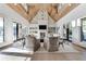 Open living room with large chairs and white built-in shelves surrounding the fireplace and television at 4585 Ryker Rd, Cumming, GA 30041