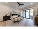 Serene bedroom with a king bed, slider door access to the backyard, and a ceiling fan at 4585 Ryker Rd, Cumming, GA 30041