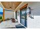 Inviting front porch with whitewashed brick, wood ceiling, and stylish outdoor lighting at 4585 Ryker Rd, Cumming, GA 30041