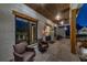 Covered porch with stone flooring, comfortable seating, and white painted brick at 4585 Ryker Rd, Cumming, GA 30041