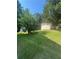 Grassy backyard with storage shed and tree lined border at 1365 Rockmart Rd, Villa Rica, GA 30180