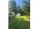 Grassy backyard with storage shed and stairs to a deck at 1365 Rockmart Rd, Villa Rica, GA 30180
