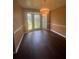 Bright dining room with elegant chandelier, hardwood floors, and large windows at 1365 Rockmart Rd, Villa Rica, GA 30180