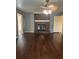 Cozy living room featuring a brick fireplace, ceiling fan, and hardwood floors at 1365 Rockmart Rd, Villa Rica, GA 30180