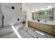 Modern bathroom showcasing glass shower with backyard views and a double vanity at 191 Darwish Dr, Mcdonough, GA 30252