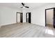 Open bedroom featuring hardwood floors, ceiling fan, and several doorway entries at 191 Darwish Dr, Mcdonough, GA 30252