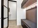 Mudroom style hallway with built-in bench seating and an open doorway at 191 Darwish Dr, Mcdonough, GA 30252