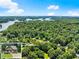 Aerial view of home nestled in lush greenery near a sparkling lake at 2850 Winchester Dr, Cumming, GA 30041