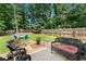 Fenced backyard featuring patio with outdoor seating, and a manicured lawn at 2850 Winchester Dr, Cumming, GA 30041