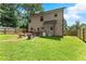 Large backyard with a well maintained lawn and an elevated rear facade at 2850 Winchester Dr, Cumming, GA 30041