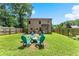 Backyard with a well-maintained lawn, a fire pit, and a wooden fence at 2850 Winchester Dr, Cumming, GA 30041