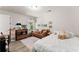 Bright bedroom with a sofa, a bed, wood floors, and natural lighting at 2850 Winchester Dr, Cumming, GA 30041