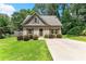 Charming home featuring manicured lawn, inviting front door, and a neatly paved driveway, surrounded by lush greenery at 2850 Winchester Dr, Cumming, GA 30041