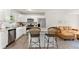 Modern kitchen with stainless steel appliances, granite countertops, bar seating and views into the open living area at 2850 Winchester Dr, Cumming, GA 30041
