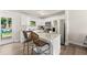 Bright kitchen boasts white cabinetry, stainless steel appliances, granite countertops, and an island with bar seating at 2850 Winchester Dr, Cumming, GA 30041