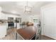Open kitchen with stainless steel appliances, white cabinets, breakfast bar, and adjacent dining area with hardwood floors at 2850 Winchester Dr, Cumming, GA 30041