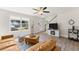 Bright living area features hardwood floors, large windows, a stylish seating arrangement and modern decor at 2850 Winchester Dr, Cumming, GA 30041