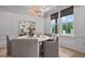 Bright dining room with a round table, stylish light fixture, and large windows at 4770 Wayt Farm Overlook, Cumming, GA 30040