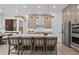 Modern kitchen featuring stainless steel appliances, a large island with seating, and stylish pendant lighting fixtures at 4770 Wayt Farm Overlook, Cumming, GA 30040