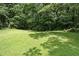Spacious backyard featuring a large grassy area, great for recreation at 5426 Martins Crossing Rd, Stone Mountain, GA 30088