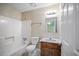 Bathroom featuring a tub-shower combination, neutral walls, and a classic vanity at 5426 Martins Crossing Rd, Stone Mountain, GA 30088