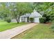 View of a single-Gathering home, featuring an attached garage and driveway at 5426 Martins Crossing Rd, Stone Mountain, GA 30088