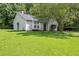Traditional home showcasing a lush green lawn and beautiful mature trees at 5426 Martins Crossing Rd, Stone Mountain, GA 30088