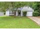 Charming one-story home featuring a well-manicured lawn and an attached single car garage at 5426 Martins Crossing Rd, Stone Mountain, GA 30088