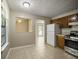 Kitchen with a stainless-steel range, a white refrigerator, and a pass through to the living area at 5426 Martins Crossing Rd, Stone Mountain, GA 30088
