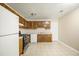 Traditional kitchen equipped with appliances, wood cabinets, and tile flooring at 5426 Martins Crossing Rd, Stone Mountain, GA 30088