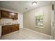 Traditional kitchen featuring tile floors, wood cabinets, and a window view at 5426 Martins Crossing Rd, Stone Mountain, GA 30088
