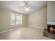 Spacious living room featuring neutral paint, ceiling fan, and fireplace at 5426 Martins Crossing Rd, Stone Mountain, GA 30088