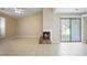 Spacious living room with a fireplace and a view of the backyard through sliding glass doors at 5426 Martins Crossing Rd, Stone Mountain, GA 30088