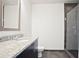 Bathroom featuring a granite countertop vanity, a toilet and glass enclosed shower at 1080 Peachtree Ne St # 804, Atlanta, GA 30309