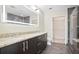 Modern bathroom features a double sink vanity, glass shower, and tiled floors at 1080 Peachtree Ne St # 804, Atlanta, GA 30309