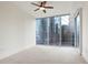 Well-lit bedroom featuring neutral carpet and floor to ceiling sliding glass doors with city views at 1080 Peachtree Ne St # 804, Atlanta, GA 30309