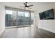 This bedroom features light gray walls and a ceiling fan. Sliding doors open to an urban balcony view at 1080 Peachtree Ne St # 804, Atlanta, GA 30309