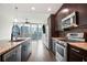 Modern kitchen includes an island with granite counters and stainless steel appliances with dark wood cabinets at 1080 Peachtree Ne St # 804, Atlanta, GA 30309