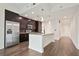 This kitchen features stainless steel appliances, granite counters, dark wood cabinets and an island at 1080 Peachtree Ne St # 804, Atlanta, GA 30309
