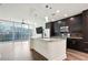 Modern kitchen with stainless steel appliances, island with granite counters, and beautiful dark wood cabinets at 1080 Peachtree Ne St # 804, Atlanta, GA 30309