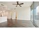 Bright living room featuring hardwood floors, ceiling fan and expansive sliding glass doors to the balcony at 1080 Peachtree Ne St # 804, Atlanta, GA 30309